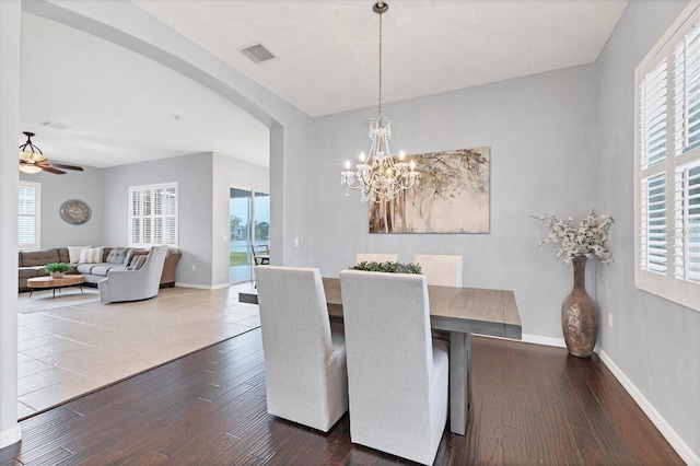 dining area featuring baseboards, hardwood / wood-style floors, and a healthy amount of sunlight