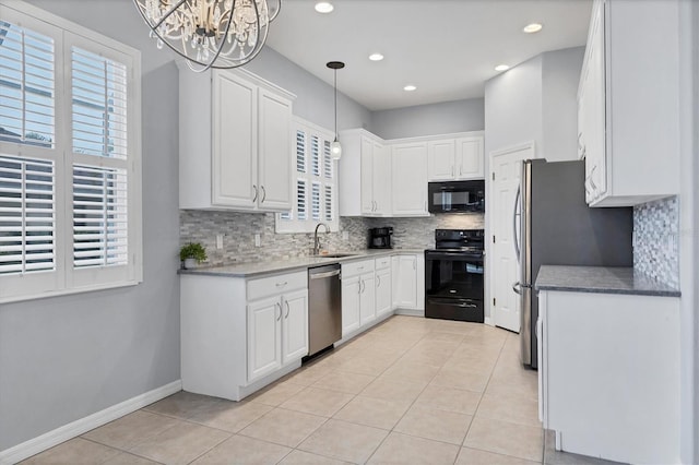 kitchen featuring a sink, tasteful backsplash, black appliances, and a notable chandelier