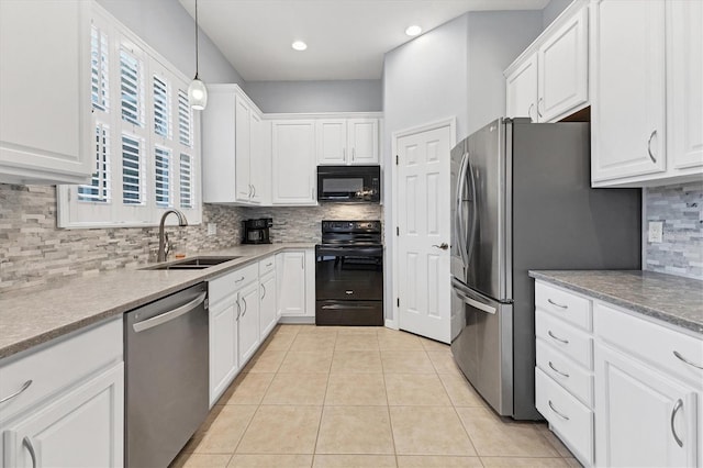 kitchen featuring white cabinets, a sink, black appliances, and backsplash