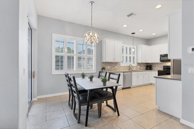 dining space with a chandelier, light tile patterned flooring, baseboards, and visible vents