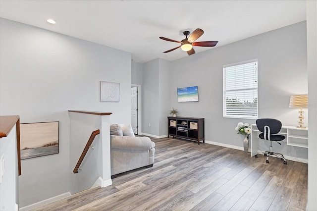 interior space with wood finished floors, ceiling fan, baseboards, and recessed lighting