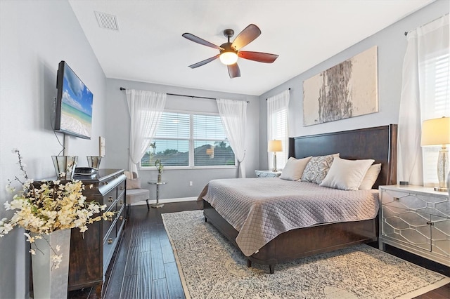 bedroom featuring dark wood-style flooring, visible vents, baseboards, and multiple windows