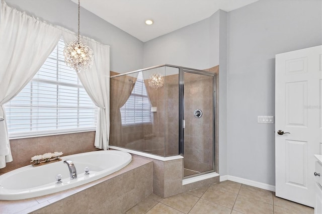 bathroom with a chandelier, a stall shower, a bath, and tile patterned flooring