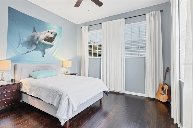 bedroom featuring dark wood-type flooring, baseboards, and a ceiling fan