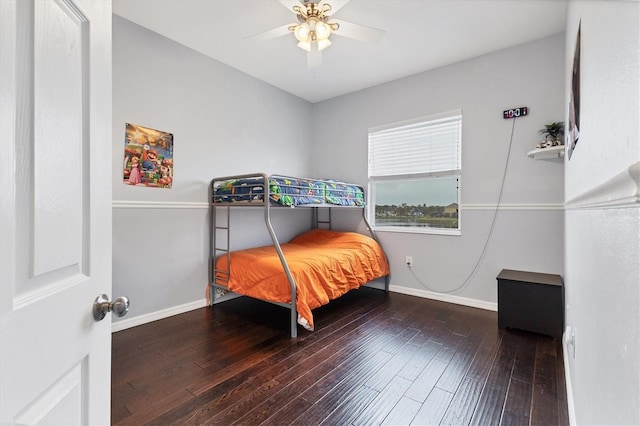 bedroom featuring hardwood / wood-style floors, ceiling fan, and baseboards
