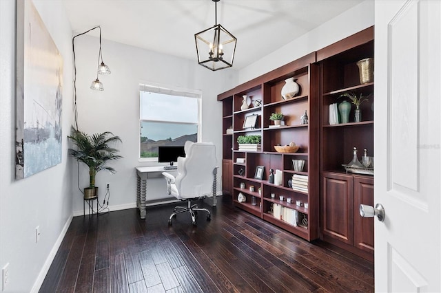 office area with a chandelier, dark wood-type flooring, and baseboards