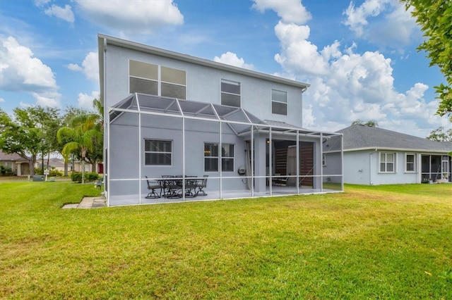 back of property featuring a yard, glass enclosure, a patio, and stucco siding