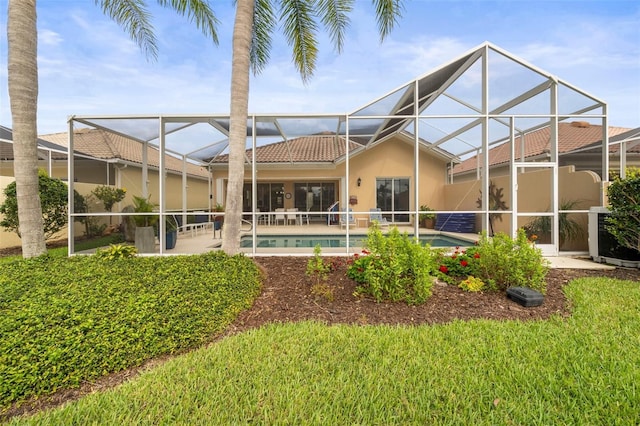 back of property with a tile roof, glass enclosure, an outdoor pool, a patio, and stucco siding