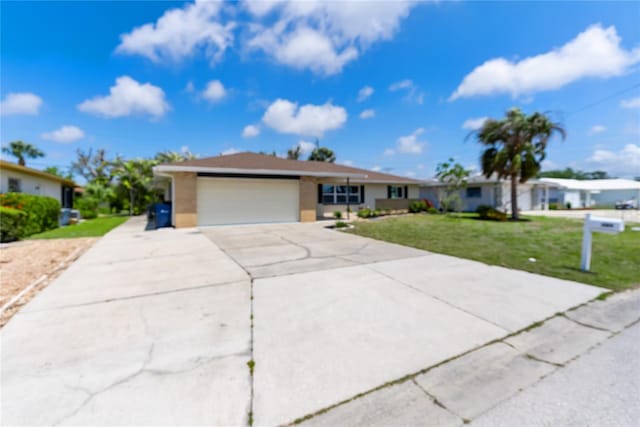 ranch-style house with a front yard, an attached garage, driveway, and stucco siding