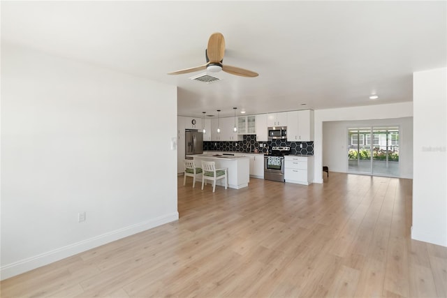 unfurnished living room featuring light wood finished floors, ceiling fan, baseboards, and visible vents