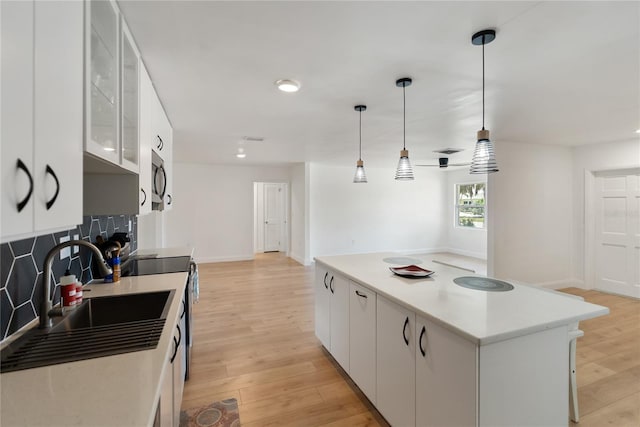 kitchen with a center island, a sink, and white cabinetry
