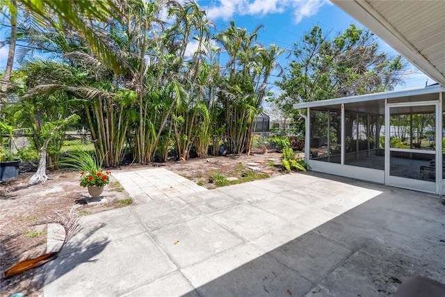 view of patio / terrace with a sunroom and fence