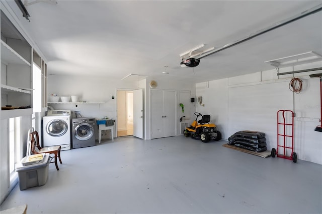 garage featuring washer and dryer and a garage door opener