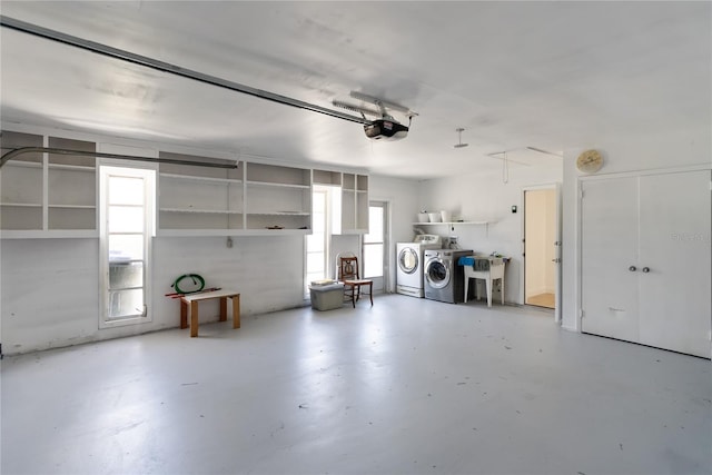 garage with independent washer and dryer and a garage door opener