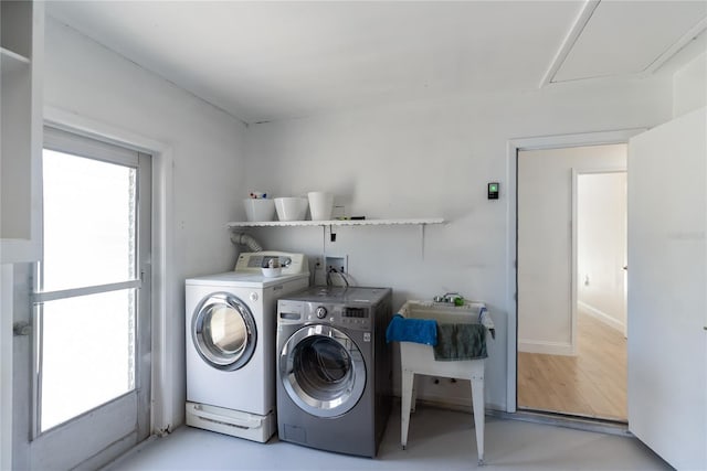 washroom featuring washer and clothes dryer and laundry area