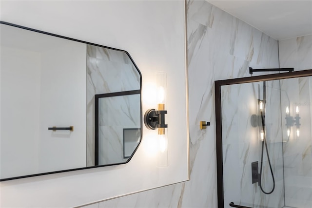 bathroom featuring a marble finish shower