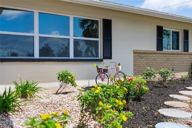 view of side of property with brick siding and stucco siding