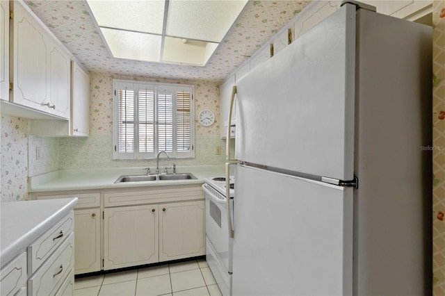 2819 Swifton Dr Unit 9, Sarasota, FL 34231 - kitchen featuring wallpapered walls, a sink, white appliances, and light countertops