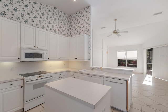 kitchen featuring a sink, visible vents, white cabinetry, and white appliances