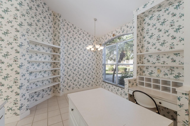 bathroom featuring a chandelier, tile patterned floors, wallpapered walls, and lofted ceiling