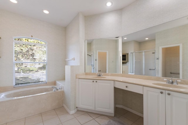 bathroom featuring plenty of natural light, a sink, a stall shower, and tile patterned flooring