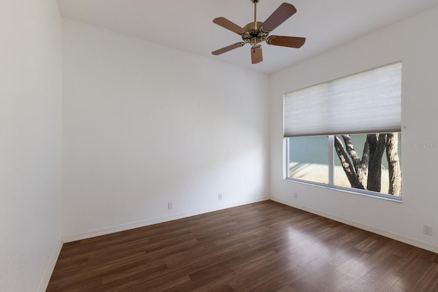 empty room with wood finished floors, ceiling fan, and baseboards