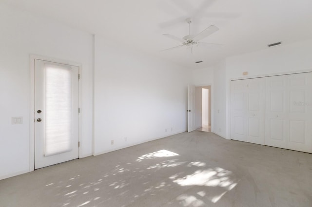 unfurnished bedroom with visible vents, a ceiling fan, and carpet