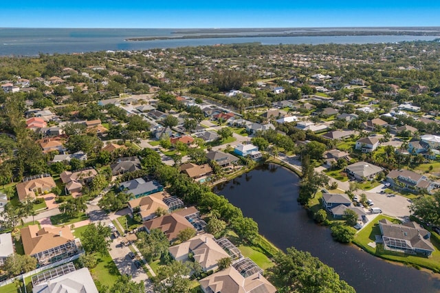 drone / aerial view featuring a residential view and a water view