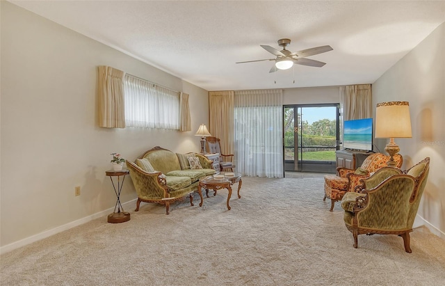 1532 Pelican Point Dr Unit Ba139, Sarasota, FL 34231 - living area featuring baseboards, ceiling fan, and carpet flooring
