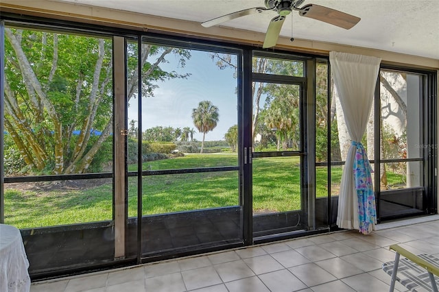 1532 Pelican Point Dr Unit Ba139, Sarasota, FL 34231 - doorway with a wealth of natural light, ceiling fan, and tile patterned flooring