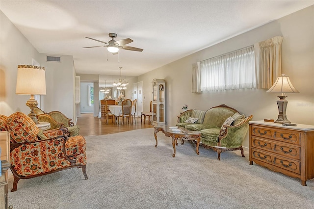 1532 Pelican Point Dr Unit Ba139, Sarasota, FL 34231 - living area featuring visible vents, baseboards, ceiling fan with notable chandelier, and carpet floors