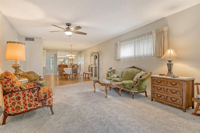 1532 Pelican Point Dr Unit Ba139, Sarasota, FL 34231 - interior space featuring ceiling fan with notable chandelier, visible vents, a wealth of natural light, and carpet flooring