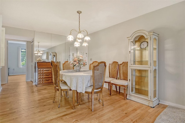 1532 Pelican Point Dr Unit Ba139, Sarasota, FL 34231 - dining area with an inviting chandelier, light wood-style flooring, and baseboards