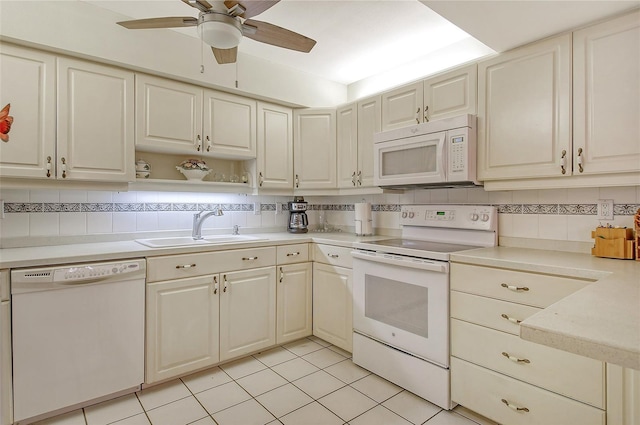 1532 Pelican Point Dr Unit Ba139, Sarasota, FL 34231 - kitchen featuring light tile patterned floors, decorative backsplash, a sink, ceiling fan, and white appliances