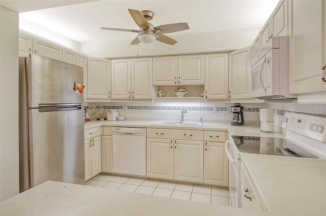 1532 Pelican Point Dr Unit Ba139, Sarasota, FL 34231 - kitchen featuring a sink, light tile patterned floors, white appliances, a ceiling fan, and light countertops