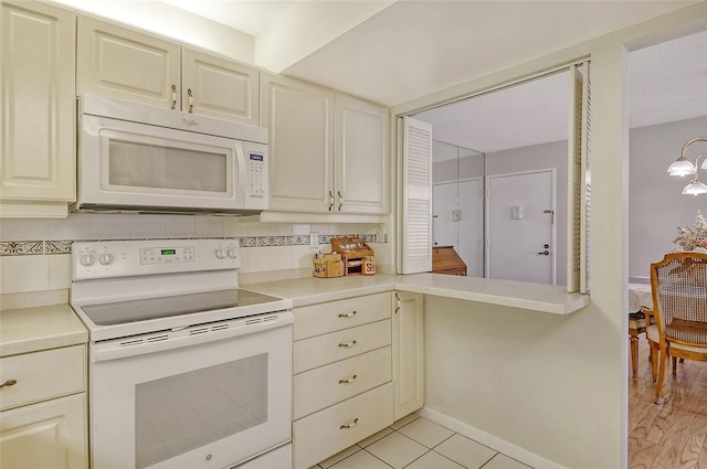 1532 Pelican Point Dr Unit Ba139, Sarasota, FL 34231 - kitchen with white appliances, light countertops, and baseboards