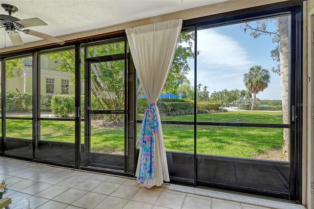 1532 Pelican Point Dr Unit Ba139, Sarasota, FL 34231 - doorway with tile patterned floors, ceiling fan, and a textured ceiling
