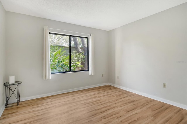 1532 Pelican Point Dr Unit Ba139, Sarasota, FL 34231 - empty room featuring baseboards and wood finished floors