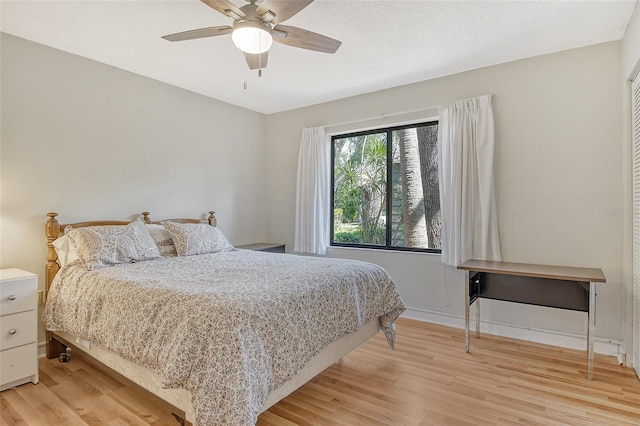 1532 Pelican Point Dr Unit Ba139, Sarasota, FL 34231 - bedroom featuring baseboards, a ceiling fan, and light wood-style flooring