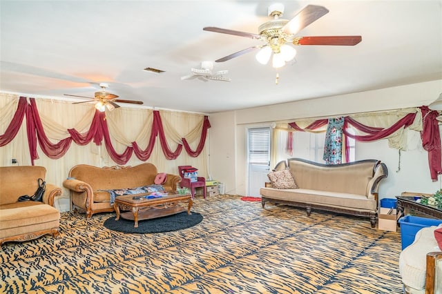 carpeted living area with visible vents and a ceiling fan