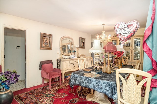 tiled dining space featuring a chandelier