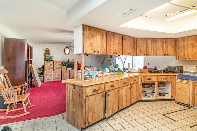kitchen featuring light countertops, visible vents, light tile patterned floors, and a toaster
