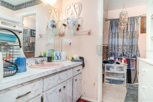 bathroom featuring vanity and baseboards