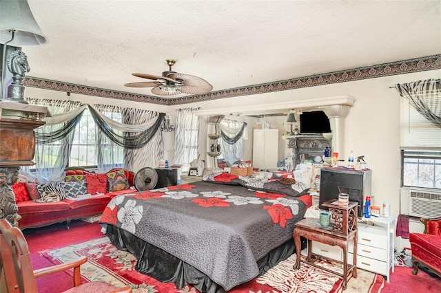 bedroom featuring a textured ceiling, ceiling fan, carpet, and a fireplace