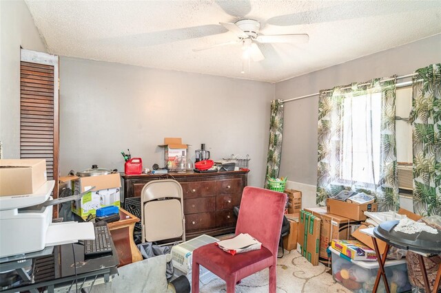 miscellaneous room featuring a textured ceiling and ceiling fan