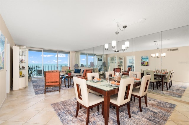 dining space featuring visible vents, a notable chandelier, and light tile patterned flooring