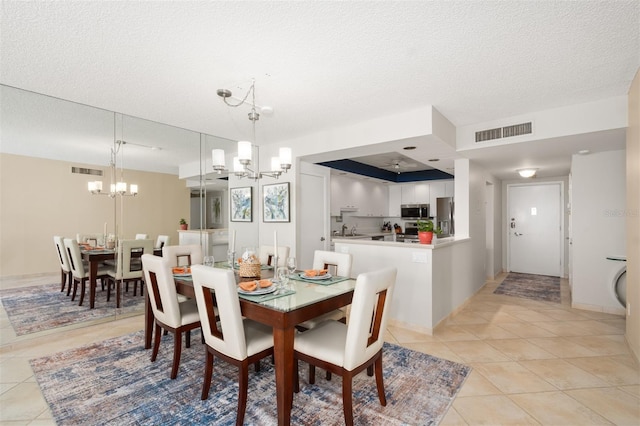 dining room featuring visible vents, a textured ceiling, a chandelier, and light tile patterned floors