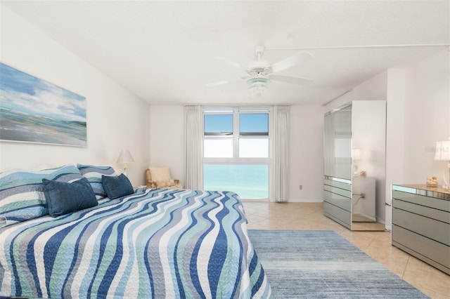 bedroom with a ceiling fan and light tile patterned flooring