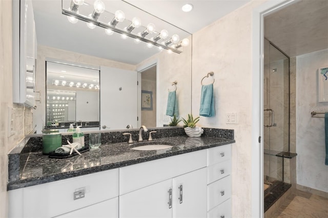 full bathroom featuring vanity and a stall shower