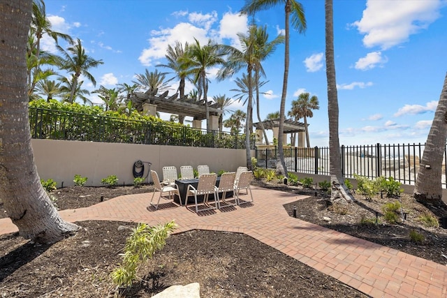 view of patio / terrace with outdoor dining area, a pergola, and fence
